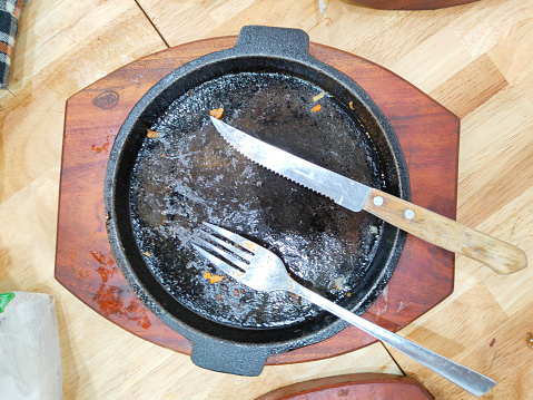 A hotplate is an oval-shaped tool that is used to serve various types of food such as steak.