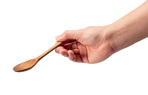 Wooden spoon in men's hand isolated on white background