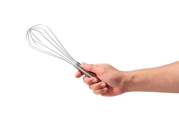 istock Men hand holding a stainless steel whisk isolated on a white background. 1871131609