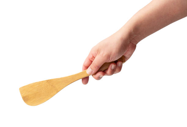 istock Wooden kitchen spatula in hand isolated on a white background. 1871131613