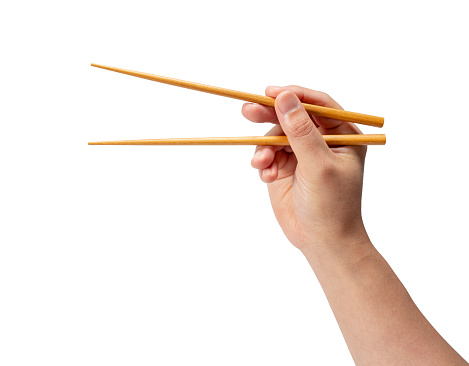 Wooden chopsticks in hand isolated on white background.