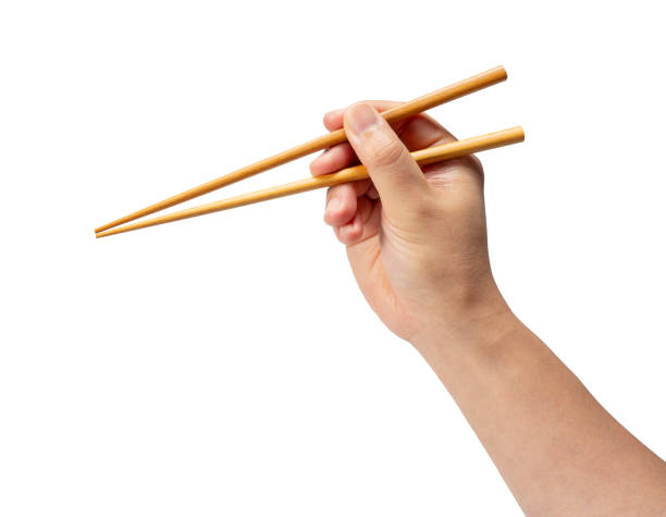 istock Wooden chopsticks in hand isolated on white background. 1871131622