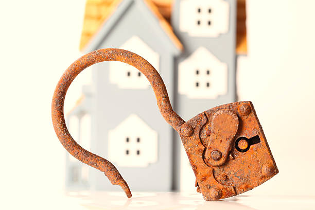 istock Very old rusty lock in front of a home 187113600