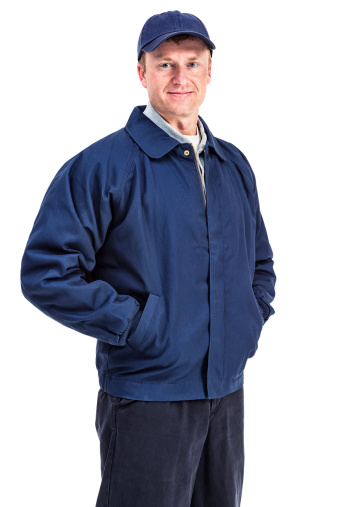 Photo of a handyman in blue workman's clothing; isolated on white.