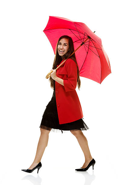 Young woman standing with umbrella