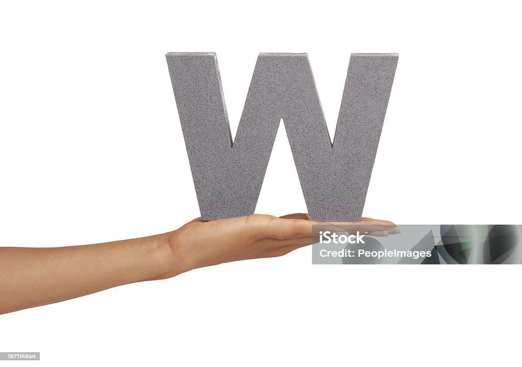 What would you do with this "W"? A young woman holding a capital letter "W" isolated on a white background Holding Aloft Stock Photo