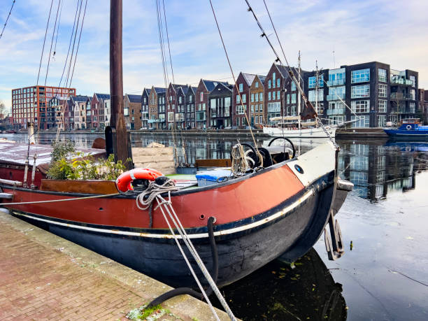Beautiful cityscape of Haarlem. Typical Dutch houses in a raw and their reflection in the canal. Old brick houses from the 17th and 18th century along a canal in the centre. Daytime view. Travel destination background, copy space.