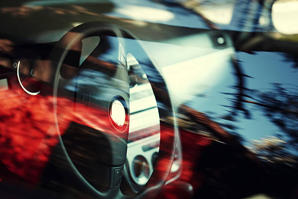 istock Close-up of a steering wheel through car window 187116105