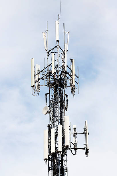 istock Closeup Cell phone tower against blue sky, copy space 187116133