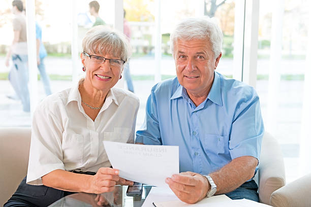 istock Elderly couple purchasing life insurance 187116649