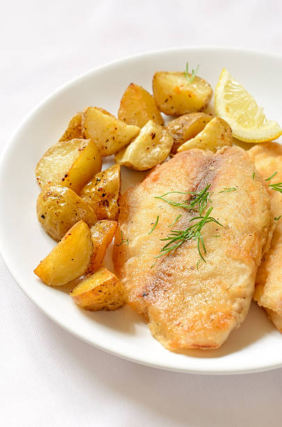 istock Fried fish fillet with baked potatoes 187116760