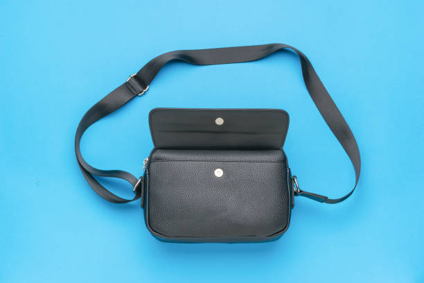 istock An open black men's bag with a belt on a blue background. 1871168121