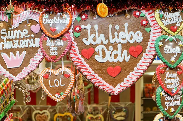 Colourful traditional "Ich liebe dich" and other gingerbread hearts for sale at a Christmas market
