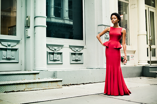 Woman wearing a red gown in Soho, New York
