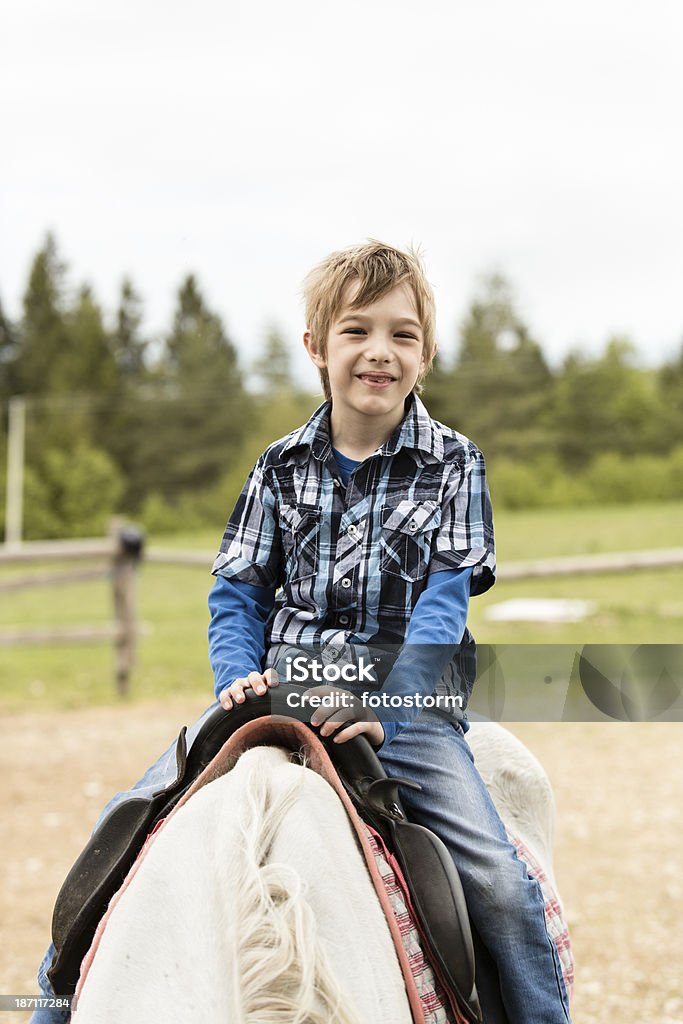 Niño montar a caballo al aire libre - Foto de stock de 6-7 años libre de derechos