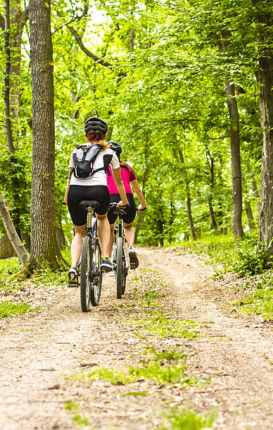 istock girls  biking in the forest 187117396