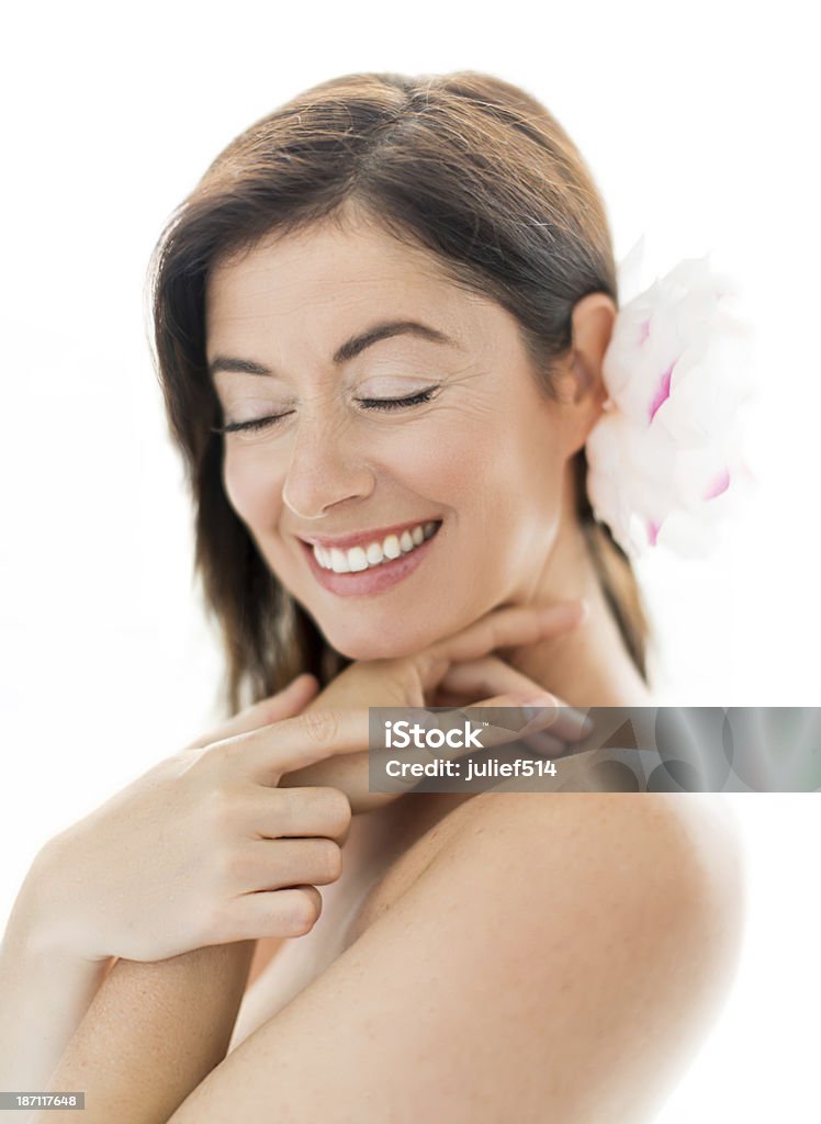 attractive forties woman with a flower in her hair portrait of a serene mature lady with her eyes closed 30-39 Years Stock Photo