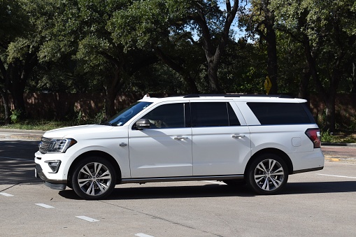 Houston, TX USA 12-19-2023 - A new white Ford Expedition King Ranch SUV cruising near Herman Park in Houston