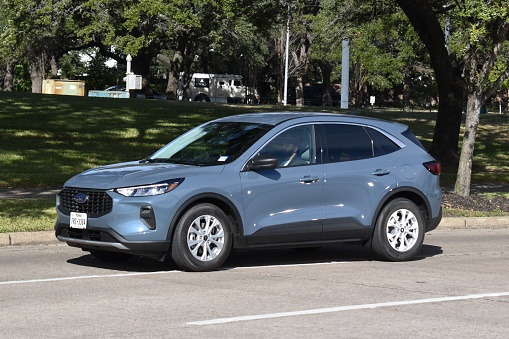 Houston, TX USA 12-19-2023 - A new blue Ford SUV cruising near Herman Park in Houston