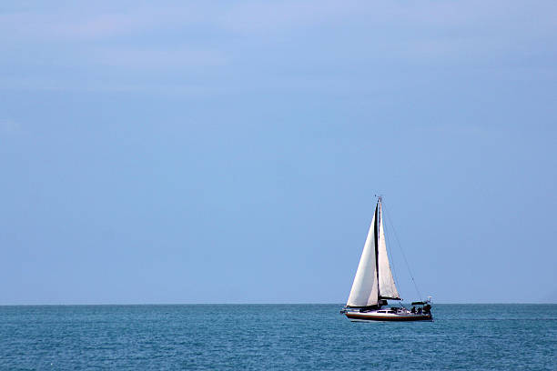 istock Boat sailing alone on the high seas 187119064