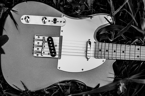 Hard-rocking electric guitar in natural mahogany wood finish, as used in rock music, heavy metal, blues, progressive rock and even jazz.