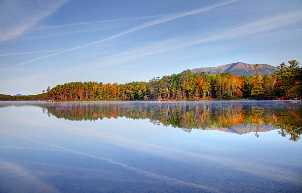 Autumn Reflection Mount Katahdin is the highest mountain in Maine. Katahdin is the centerpiece of Baxter State Park: a steep, tall mountain formed from underground magma. Photo taken during the fall foliage season. Maine fall foliage ranks with the best in New England bringing out some of  the most beautiful foliage in the United States mt katahdin stock pictures, royalty-free photos & images