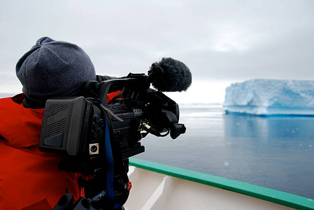 istock cameraman filming an iceberg 187120912
