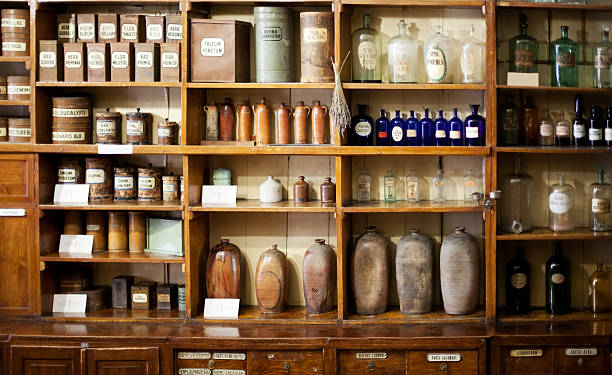 Old pharmacy Bottles on the shelf in old pharmacy homeopathic medicine photos stock pictures, royalty-free photos & images