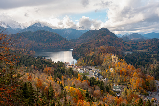 Hohenschwangau, Germany - October 17, 2015: view of Neuschwanstein Castle on october 17th near Hohenschwangau, Germany during autumn afternoon surrounded by fall colours
