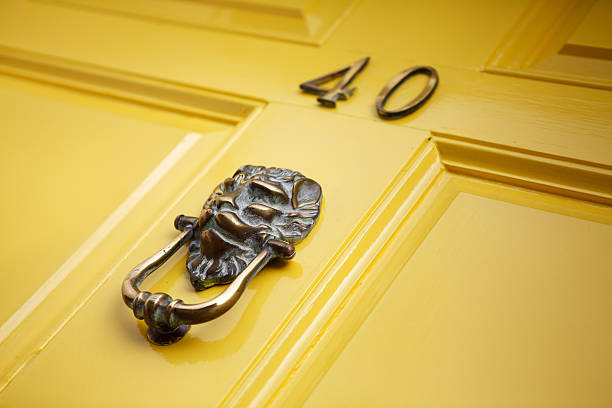 yellow door with knocker stock photo