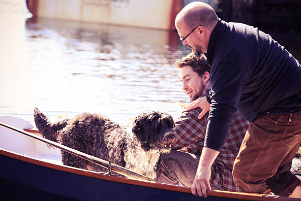 istock Two Men in Dory with Portugese Water Dog 187124022