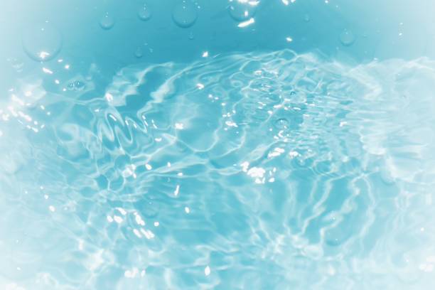 istock Defocus blurred transparent blue colored clear calm water surface texture with splashes and bubbles. Trendy abstract nature background. Water waves in sunlight with copy space. Blue watercolor shining 1871241412