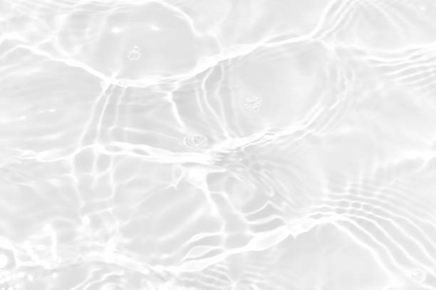 istock White water with ripples on the surface. Defocus blurred transparent white colored clear calm water surface texture with splashes and bubbles. Water waves with shining pattern texture background. 1871241575
