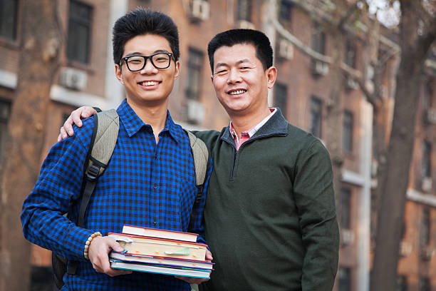 Father and son portrait in front of dormitory Father and son portrait in front of dormitory college student and parent stock pictures, royalty-free photos & images