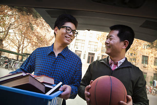 istock Father and Son unpacking car in front of dormitory 187124378