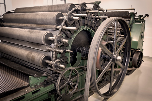 Sepia toned image of textile machine detail in manufacturing plant