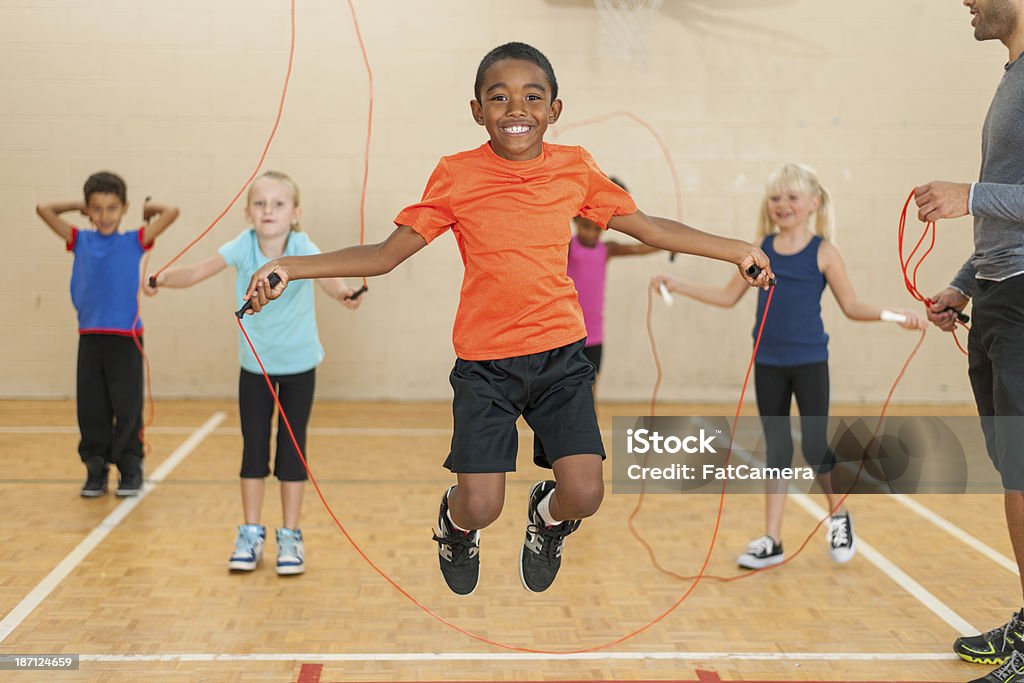 Diverse Group Of Elementary Children Jumping Rope Stock Photo