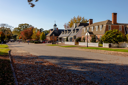 Merchants Square and Resort Historic District in Colonial Williamsburg in Virginia. Shops and stores line the street in autumnal day