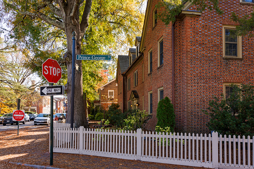 Walking on Prince George Street with brick houses, historical buildings in Williamsburg, Virginia