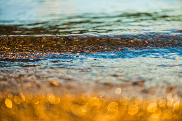 istock Golden pebbles at beach 187125666