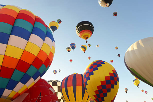 Hot Air Balloons on a Beautiful Sunshiny Day Hot Air Balloons, flying and getting ready to fly, on a beautiful sunshiny day, making the colors of the balloons very bright, in a festival near Albuquerque, New Mexico bernalillo county stock pictures, royalty-free photos & images