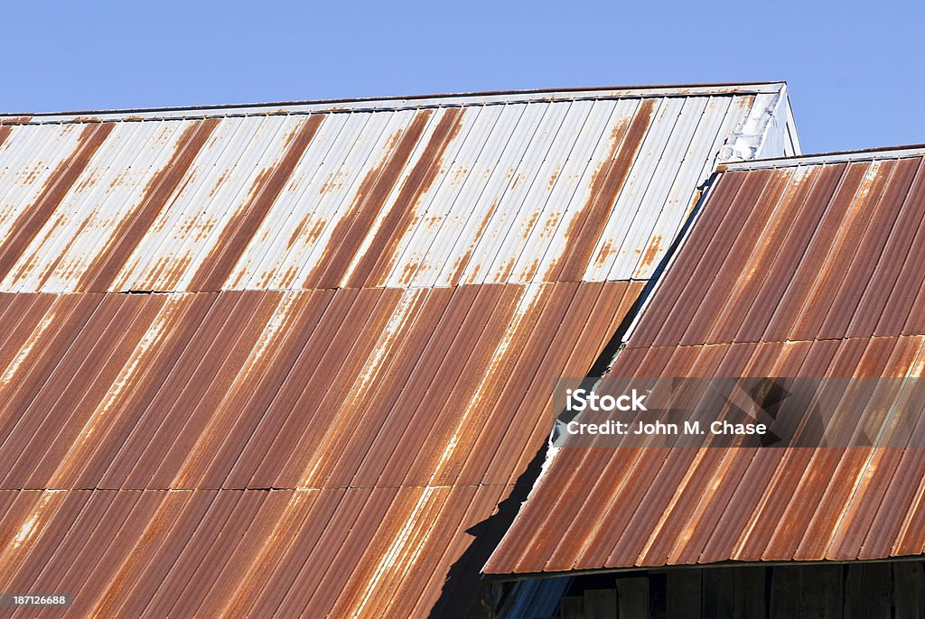 Rusty Barn Roof Rusting metal barn roof atop an old barn in New England. Agricultural Equipment Stock Photo