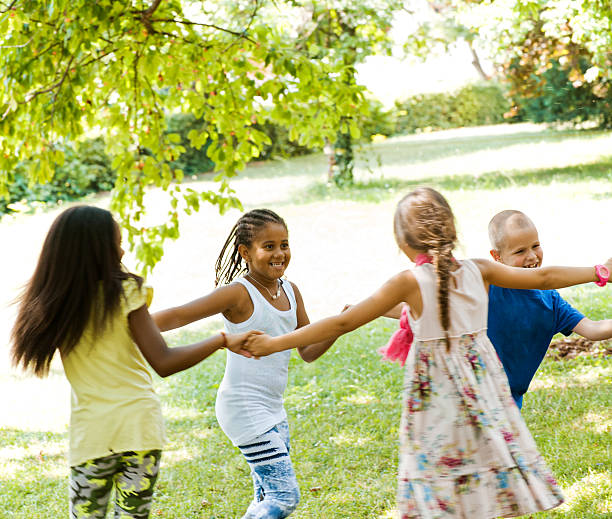 istock Four young children having fun outside 187127259