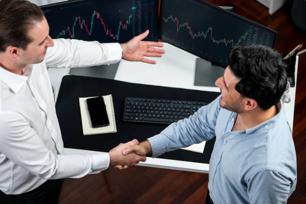 istock Successful traders in stock market dealing investment project. Sellable. 1871274133