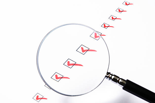 istock Close-up of check box with magnifying glass on white background 187129319