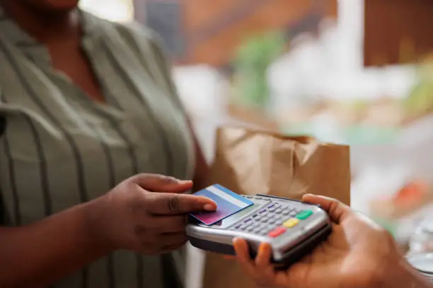 Photo of Black woman buying organic produce