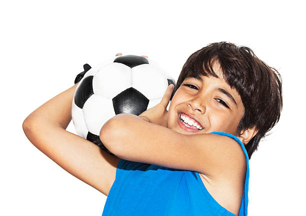 istock Cute boy playing football 187129575