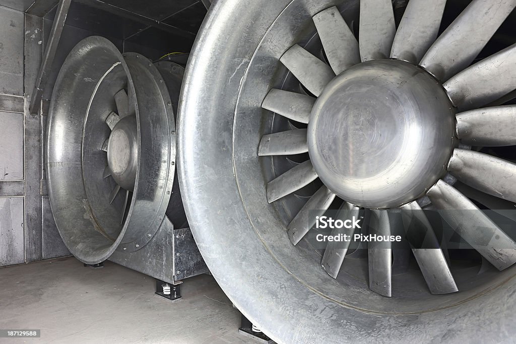 Big Fans Huge size ventilation fans inside an air duct. The air canal is located inside a ventilation chamber of a technical service building which belongs to a public transportation system. The ventilation chamber is connected to a ventilation shaft where air flow of the transportation system is controlled. Air Conditioner Stock Photo