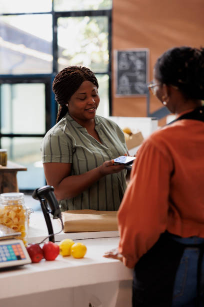 istock Smiling woman at checkout 1871296176