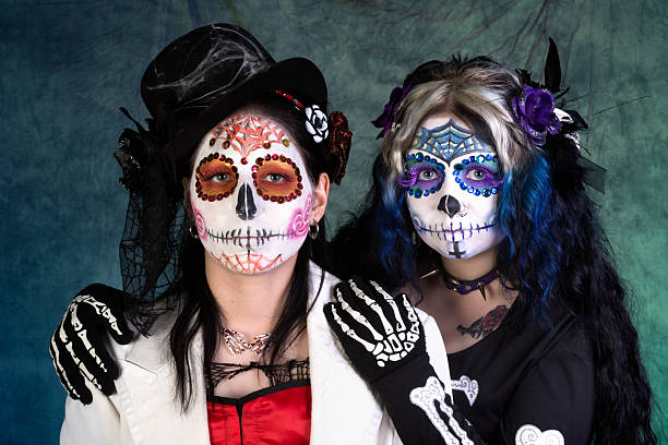 istock Spooky women in Sugar Skull makeup on blue/green. 187129694